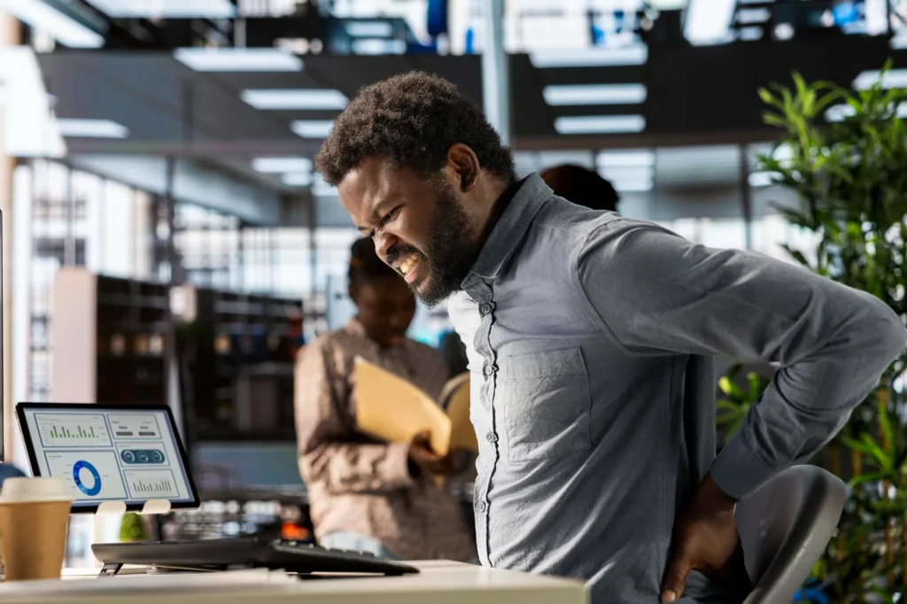 A mans having back pain while working